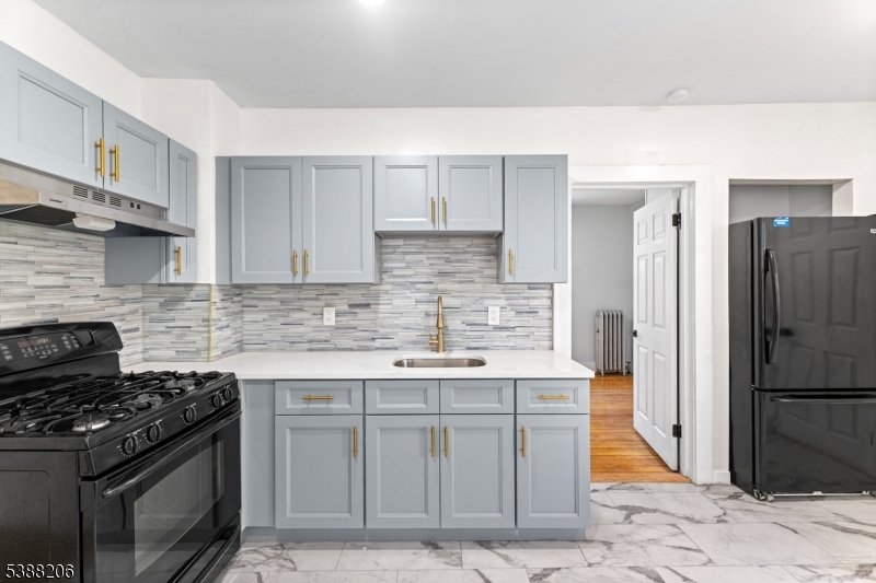 3202 Tremley Point Road Linden, NJ 07036 - Photo 19 of 41 a kitchen with stainless steel appliances granite countertop a stove a refrigerator and a sink