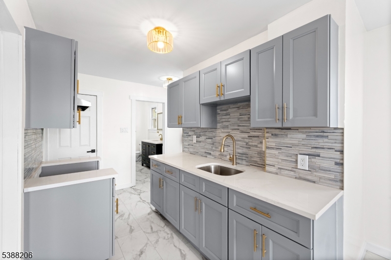 3202 Tremley Point Road Linden, NJ 07036 - Photo 22 of 41 a kitchen with a sink and cabinets