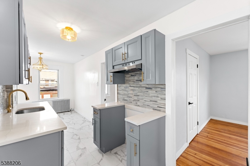 3202 Tremley Point Road Linden, NJ 07036 - Photo 25 of 41 a kitchen with granite countertop a sink stainless steel appliances and cabinets
