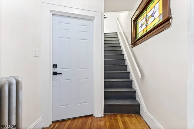 a view of an entryway with wooden floor
