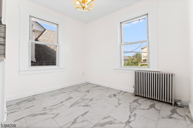 3202 Tremley Point Road Linden, NJ 07036 - Photo 27 of 41 an empty room with a window and mirror