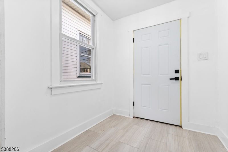 3202 Tremley Point Road Linden, NJ 07036 - Photo 30 of 41 a view of an empty room with wooden floor and a window