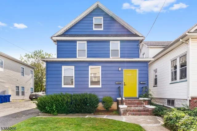 a view of a brick house with a yard