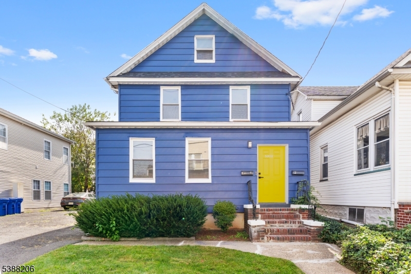 3202 Tremley Point Road Linden, NJ 07036 - Photo 3 of 41 a view of a brick house with a yard