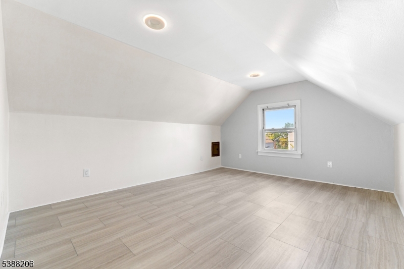 3202 Tremley Point Road Linden, NJ 07036 - Photo 33 of 41 an empty room with a window and wooden floor
