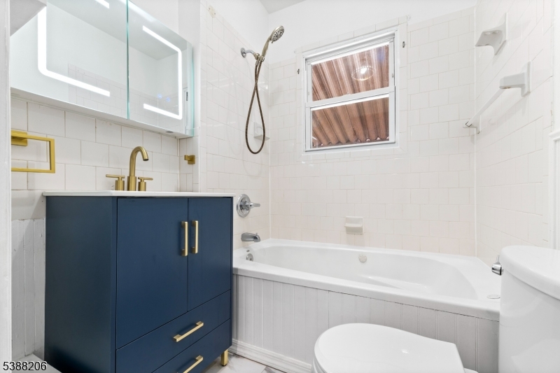 3202 Tremley Point Road Linden, NJ 07036 - Photo 36 of 41 a bathroom with a granite countertop sink toilet and shower