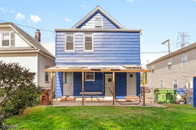 a view of a house with a yard and sitting area