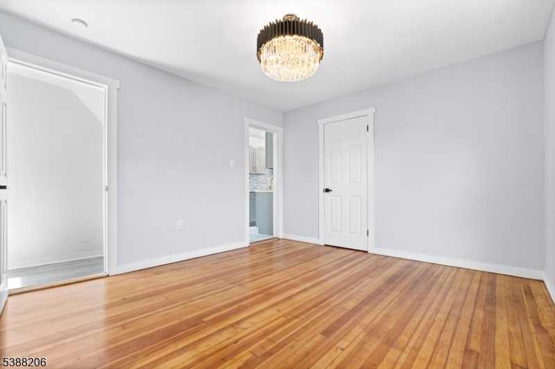 3202 Tremley Point Road Linden, NJ 07036 - Photo 8 of 41 a view of an empty room with wooden floor and a window