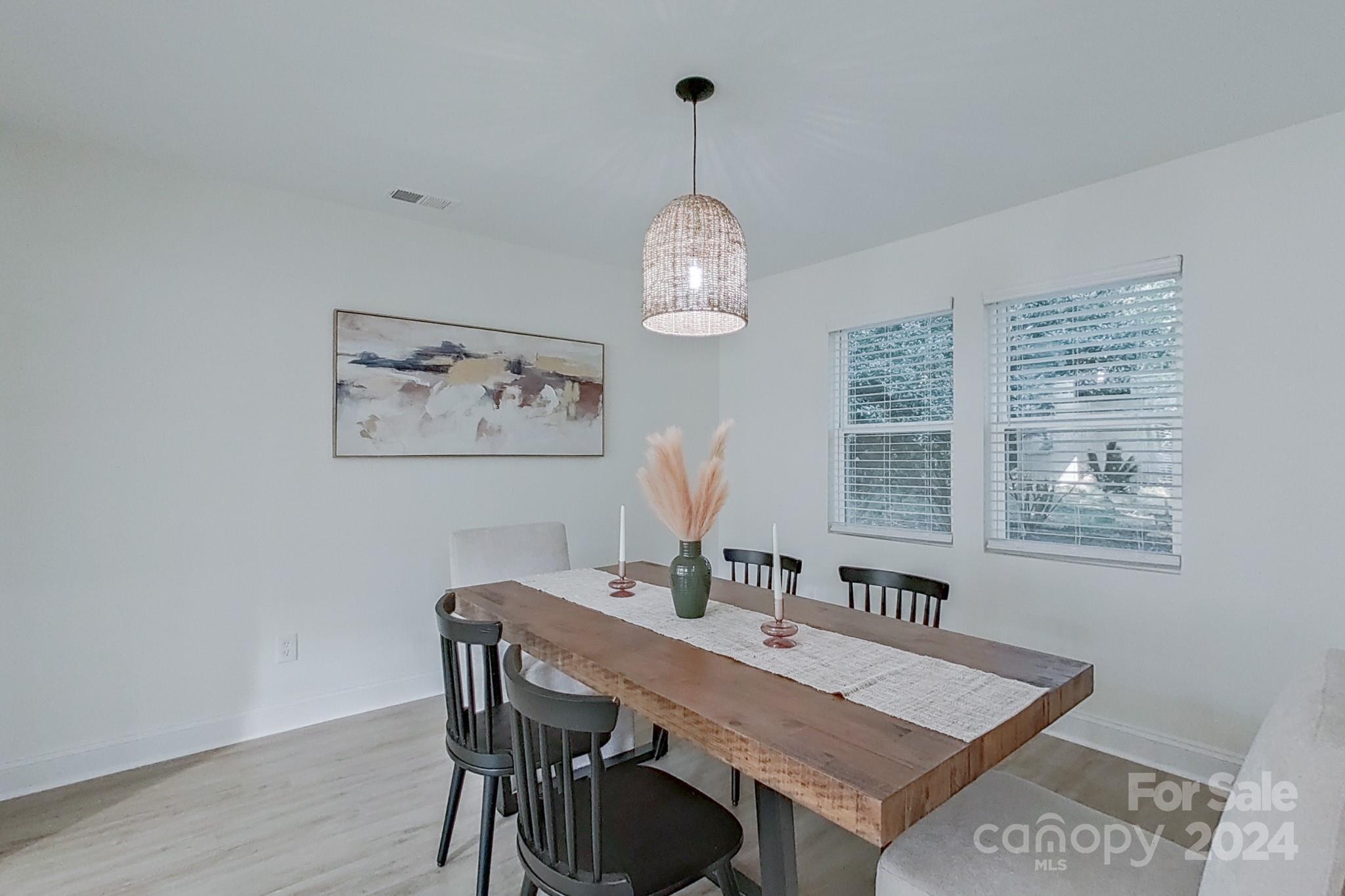 5710 Stream Ridge Drive Charlotte, NC 28269 - Photo 16 of 48 a view of a dining room with furniture window and wooden floor