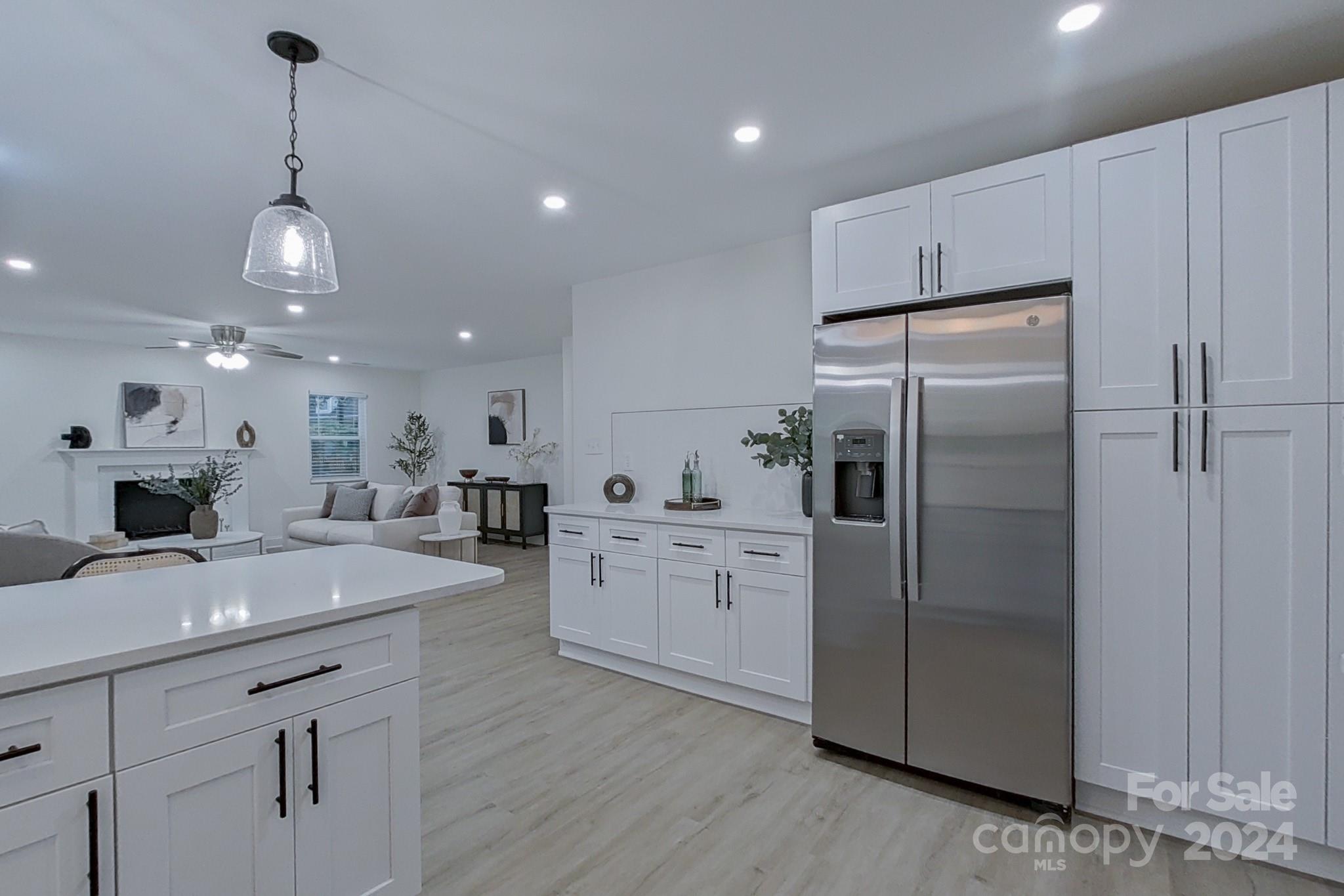 5710 Stream Ridge Drive Charlotte, NC 28269 - Photo 17 of 48 a kitchen with a refrigerator a sink dishwasher a oven and a dining table with wooden floor