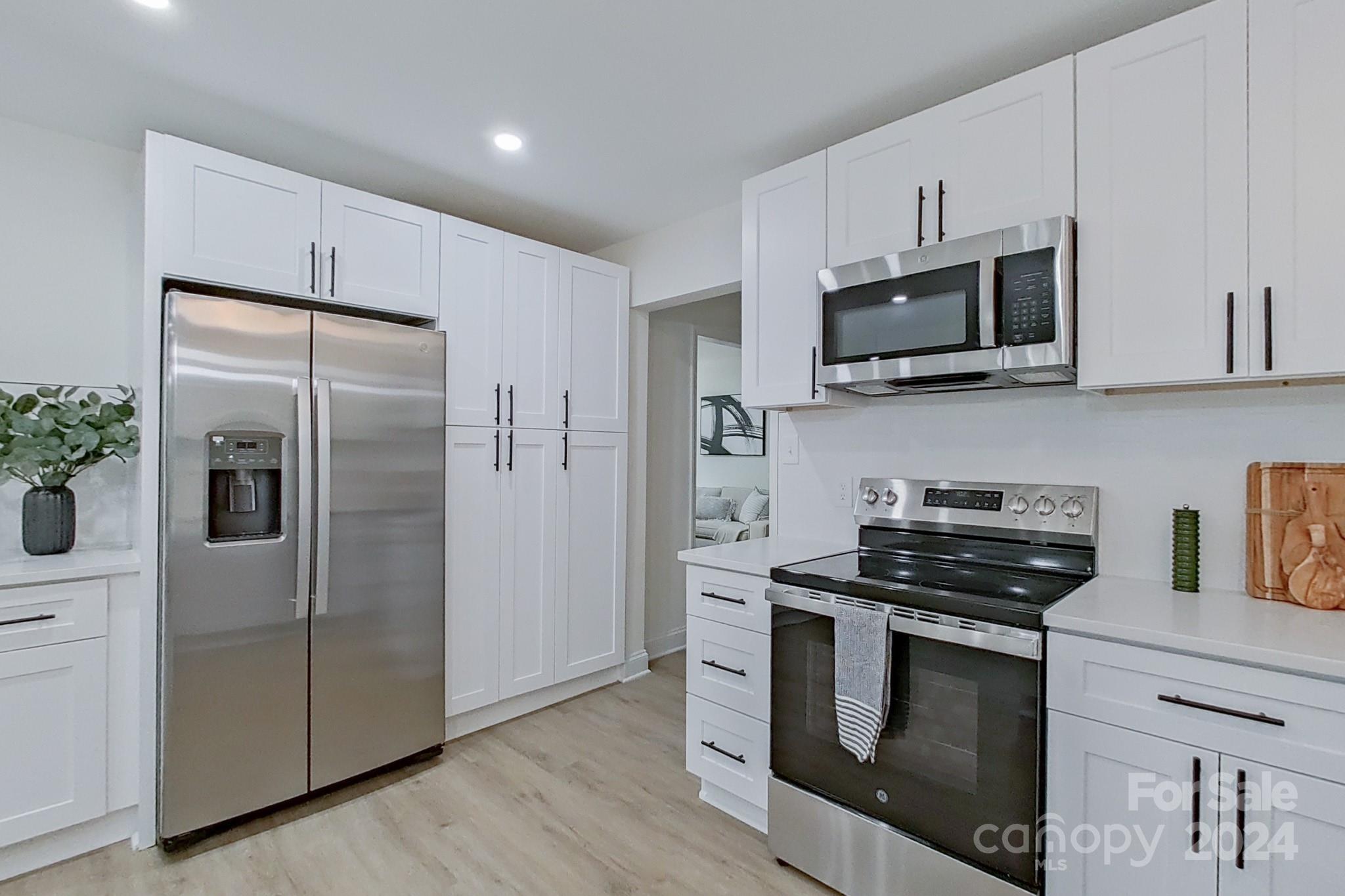 5710 Stream Ridge Drive Charlotte, NC 28269 - Photo 20 of 48 a kitchen with stainless steel appliances a refrigerator stove and microwave
