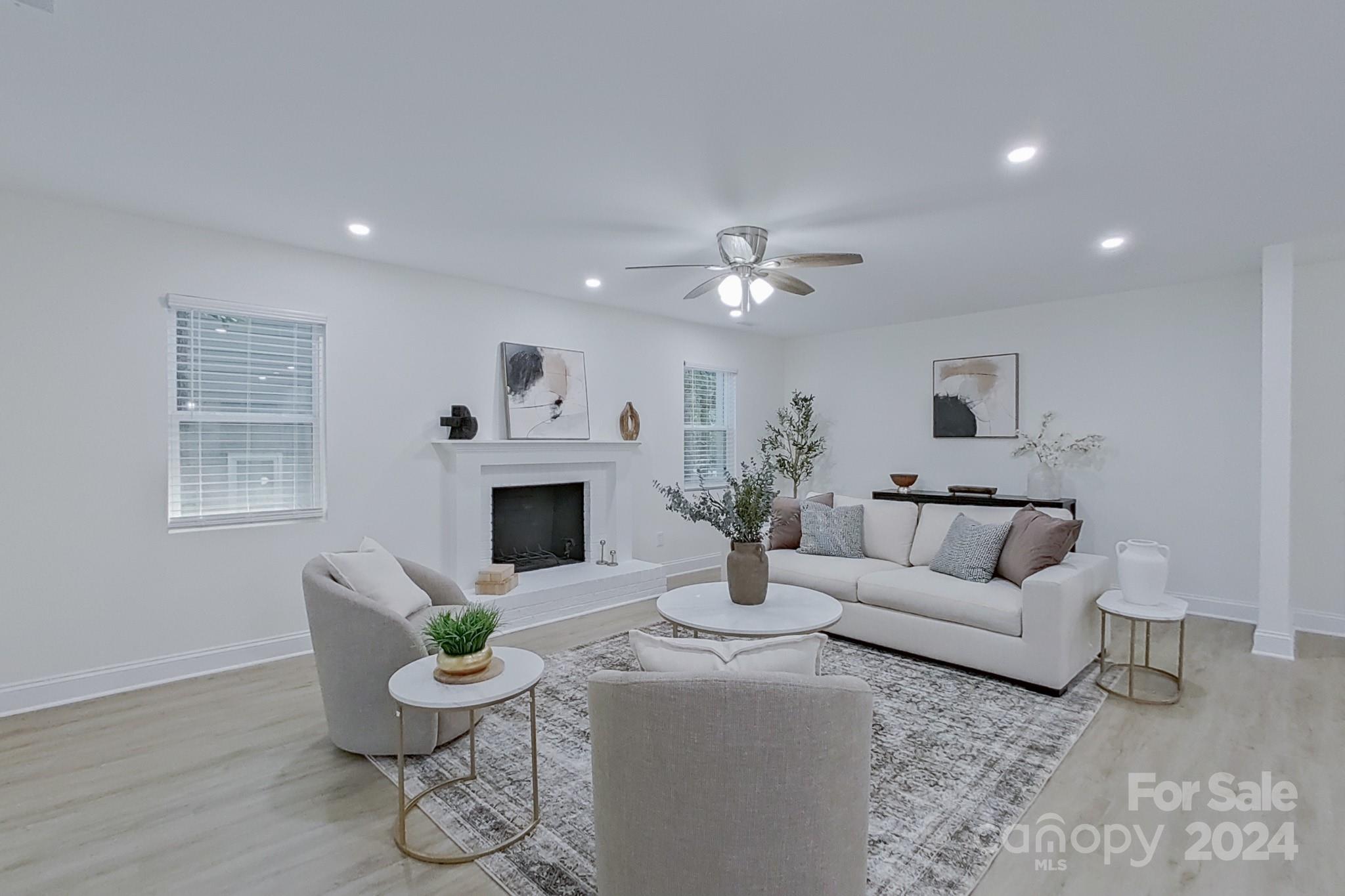 5710 Stream Ridge Drive Charlotte, NC 28269 - Photo 24 of 48 a living room with furniture a fireplace and a table