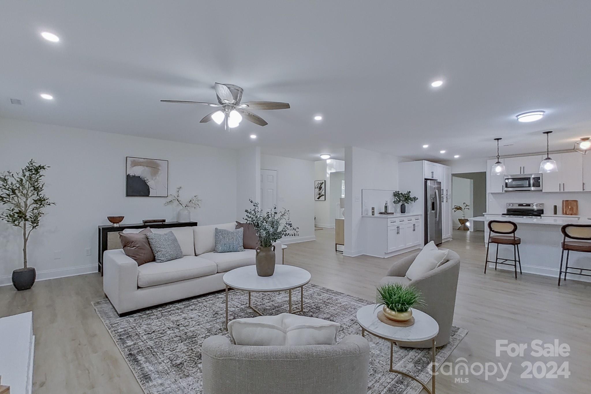 5710 Stream Ridge Drive Charlotte, NC 28269 - Photo 25 of 48 a living room with furniture kitchen view and a potted plant