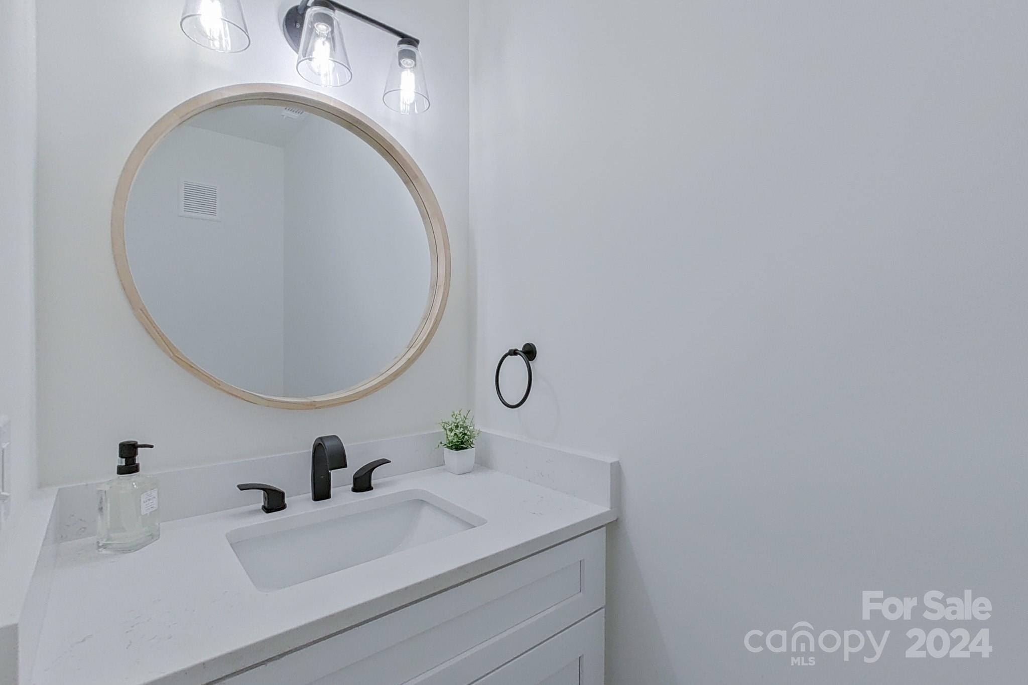5710 Stream Ridge Drive Charlotte, NC 28269 - Photo 27 of 48 a bathroom with a sink and a mirror