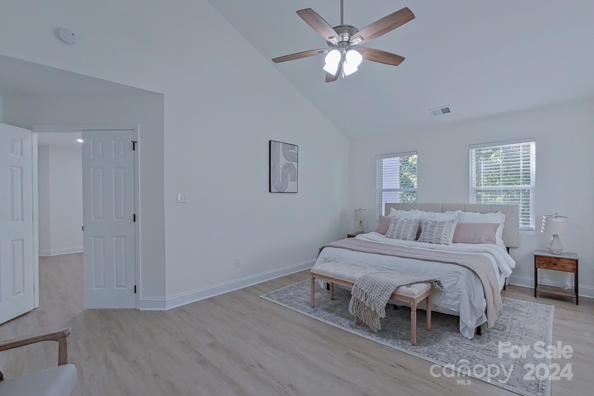 5710 Stream Ridge Drive Charlotte, NC 28269 - Photo 29 of 48 a bedroom with a bed and a chandelier