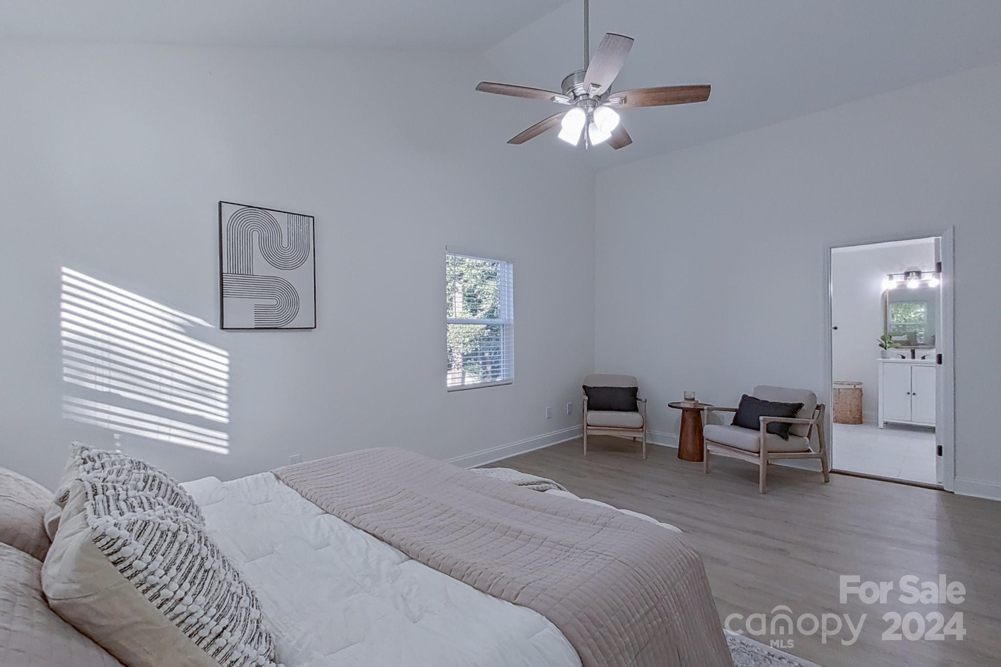 5710 Stream Ridge Drive Charlotte, NC 28269 - Photo 30 of 48 a bedroom with a bed and a chandelier