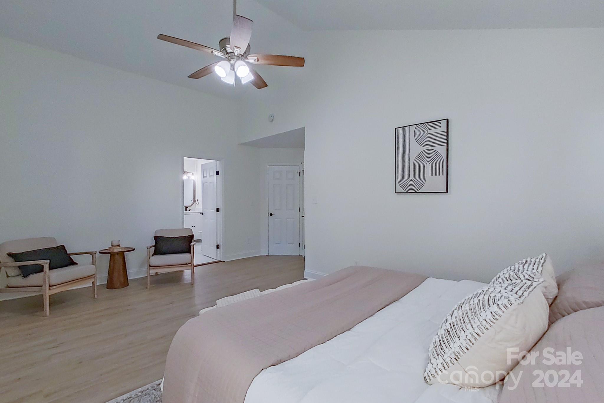 5710 Stream Ridge Drive Charlotte, NC 28269 - Photo 31 of 48 a bedroom with a bed and a chandelier