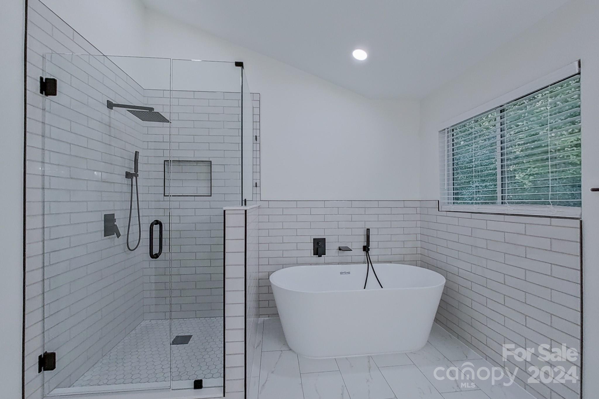 5710 Stream Ridge Drive Charlotte, NC 28269 - Photo 33 of 48 a bathroom with a bathtub and shower