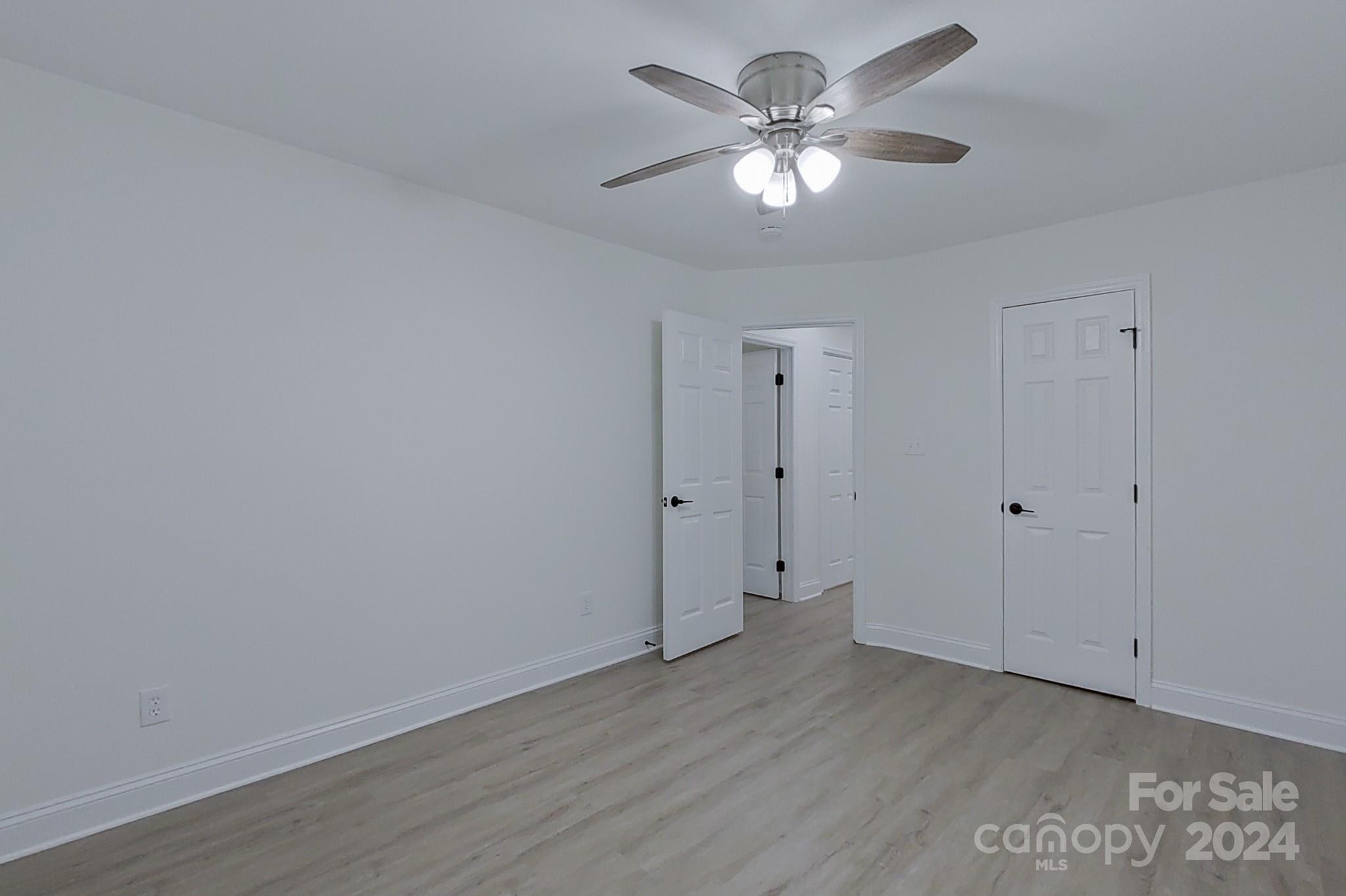 5710 Stream Ridge Drive Charlotte, NC 28269 - Photo 39 of 48 a view of an empty room with a chandelier fan