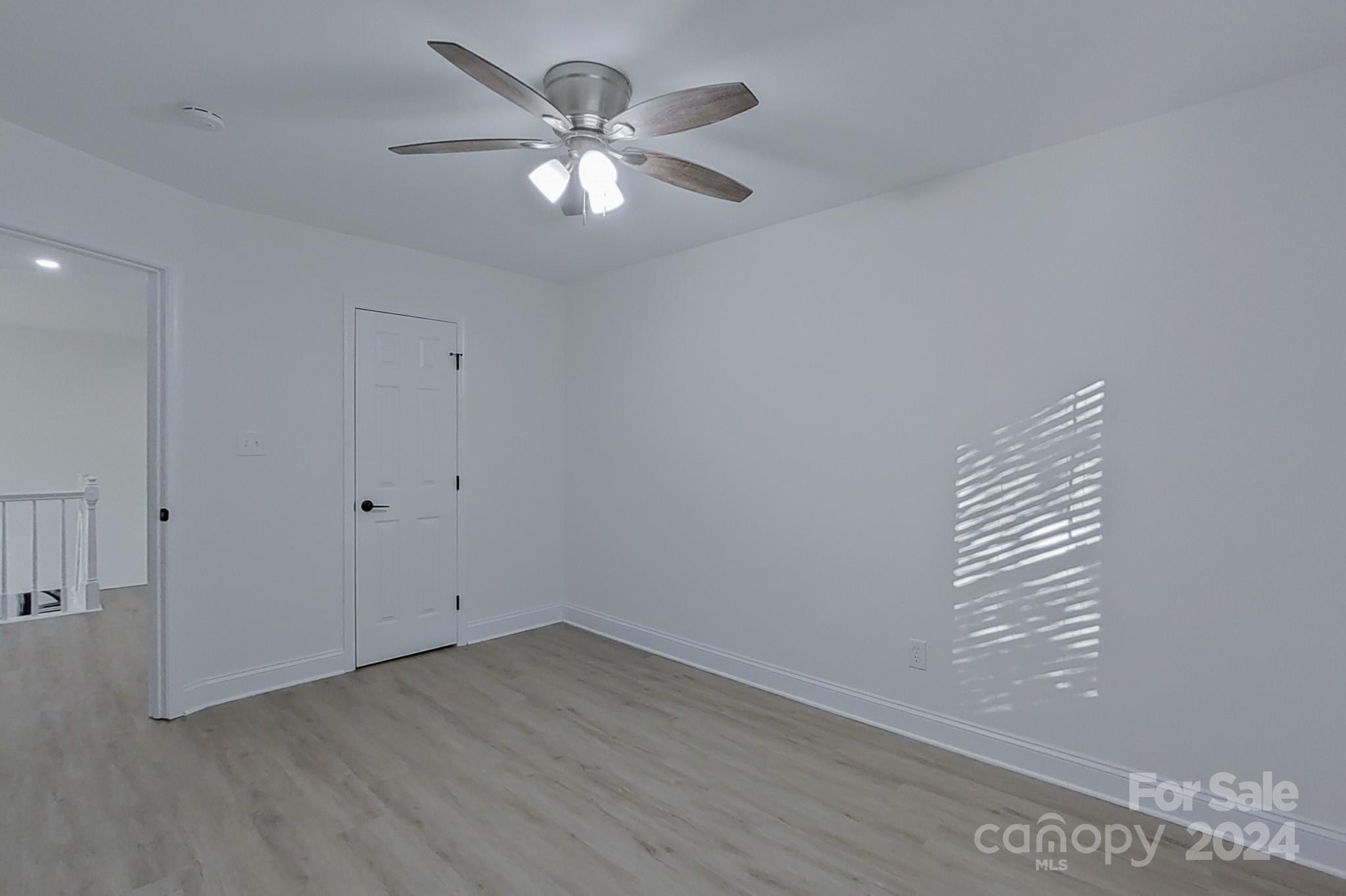 5710 Stream Ridge Drive Charlotte, NC 28269 - Photo 40 of 48 an empty room with wooden floor and windows