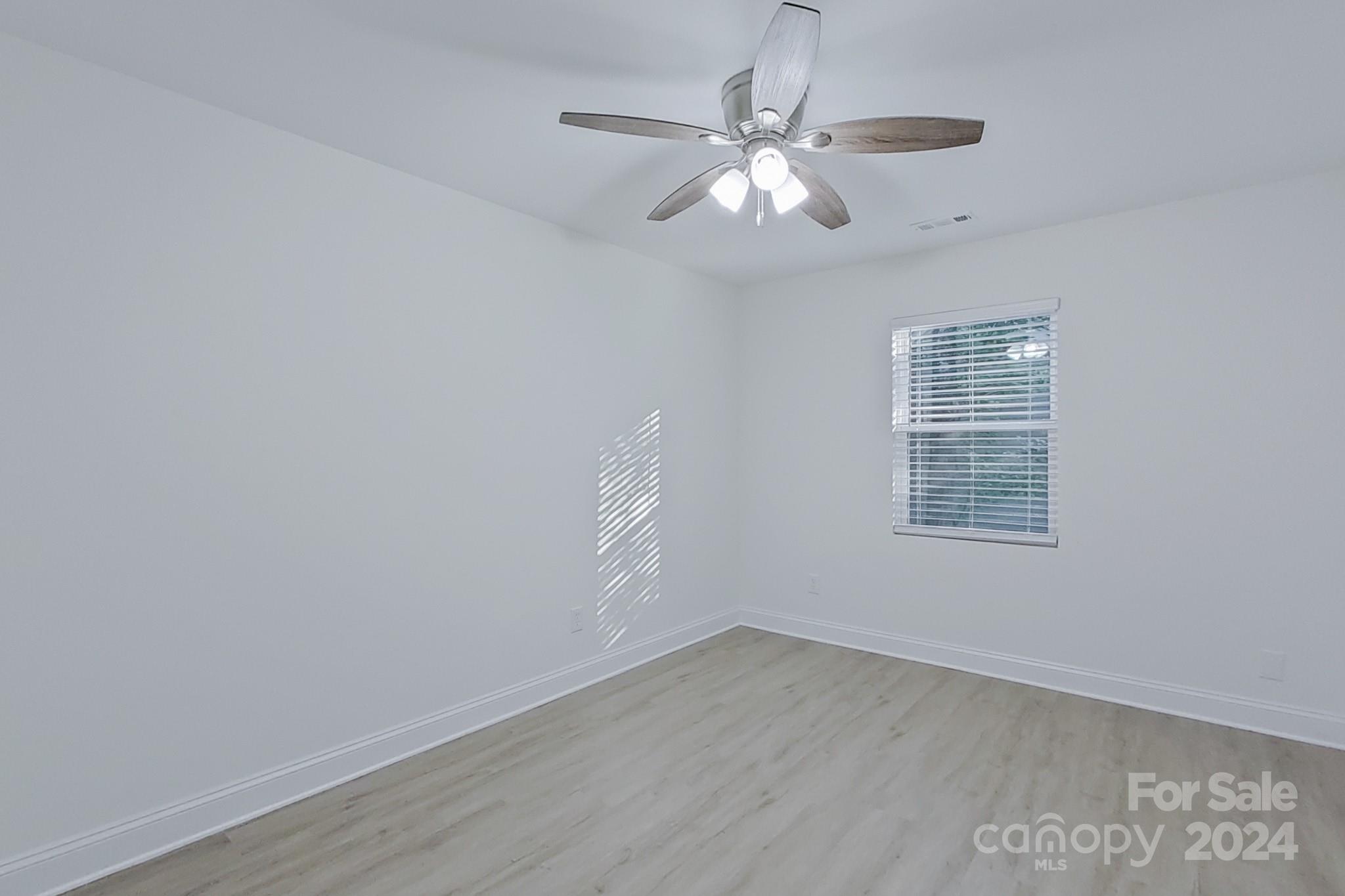 5710 Stream Ridge Drive Charlotte, NC 28269 - Photo 41 of 48 an empty room with wooden floor and windows