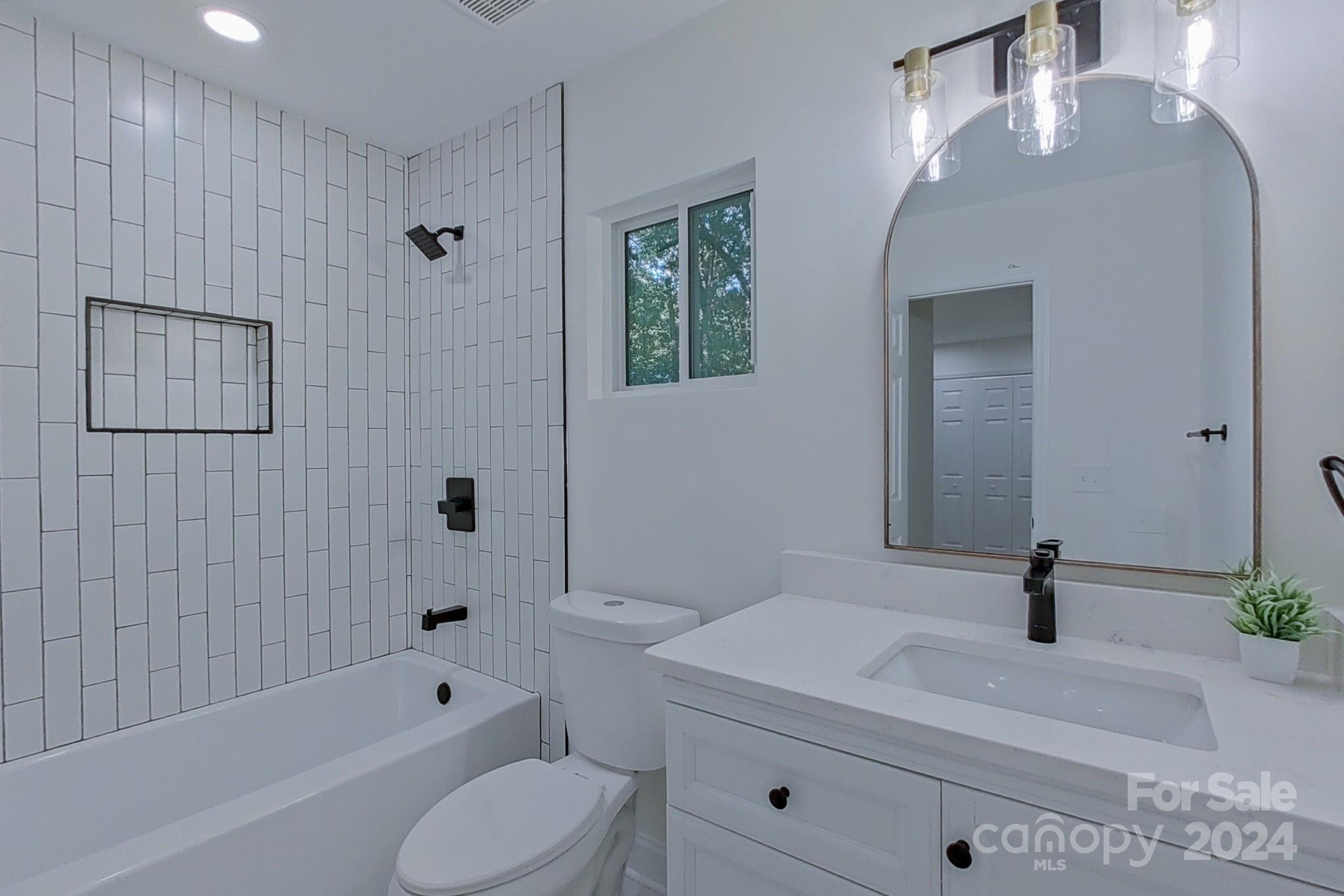 5710 Stream Ridge Drive Charlotte, NC 28269 - Photo 42 of 48 a bathroom with a sink a toilet and shower