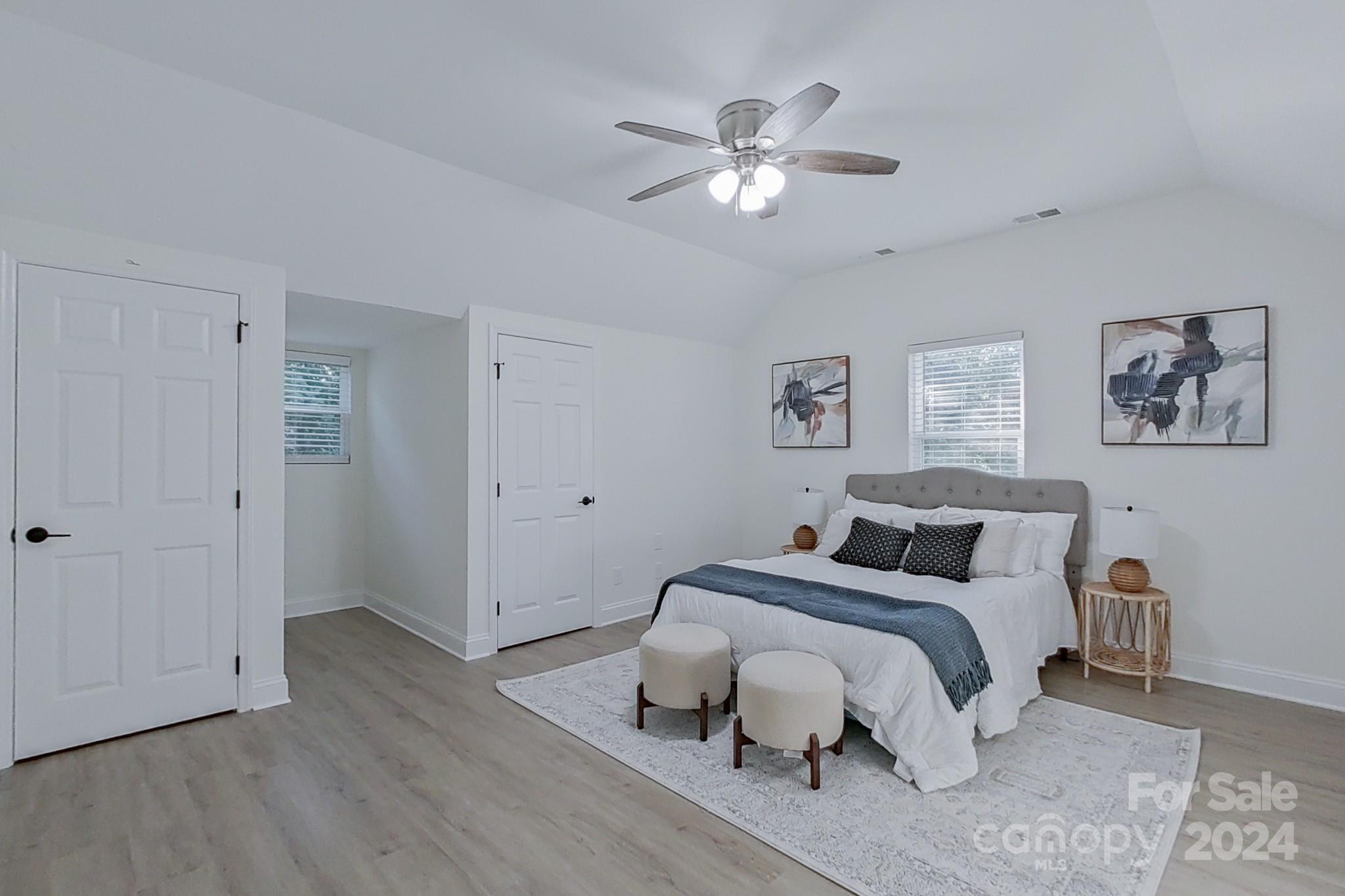 5710 Stream Ridge Drive Charlotte, NC 28269 - Photo 43 of 48 a bedroom with bed and a chandelier