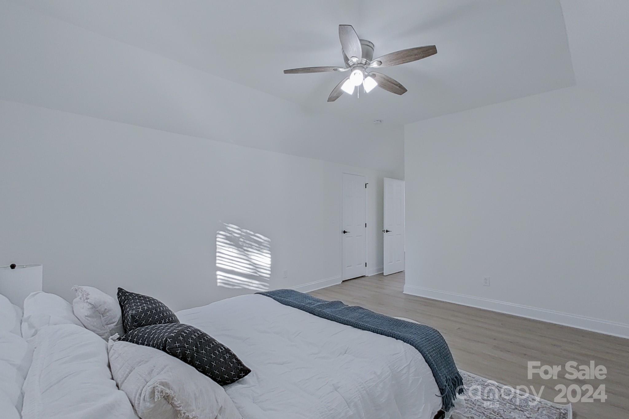 5710 Stream Ridge Drive Charlotte, NC 28269 - Photo 44 of 48 a bedroom with a bed and a chandelier