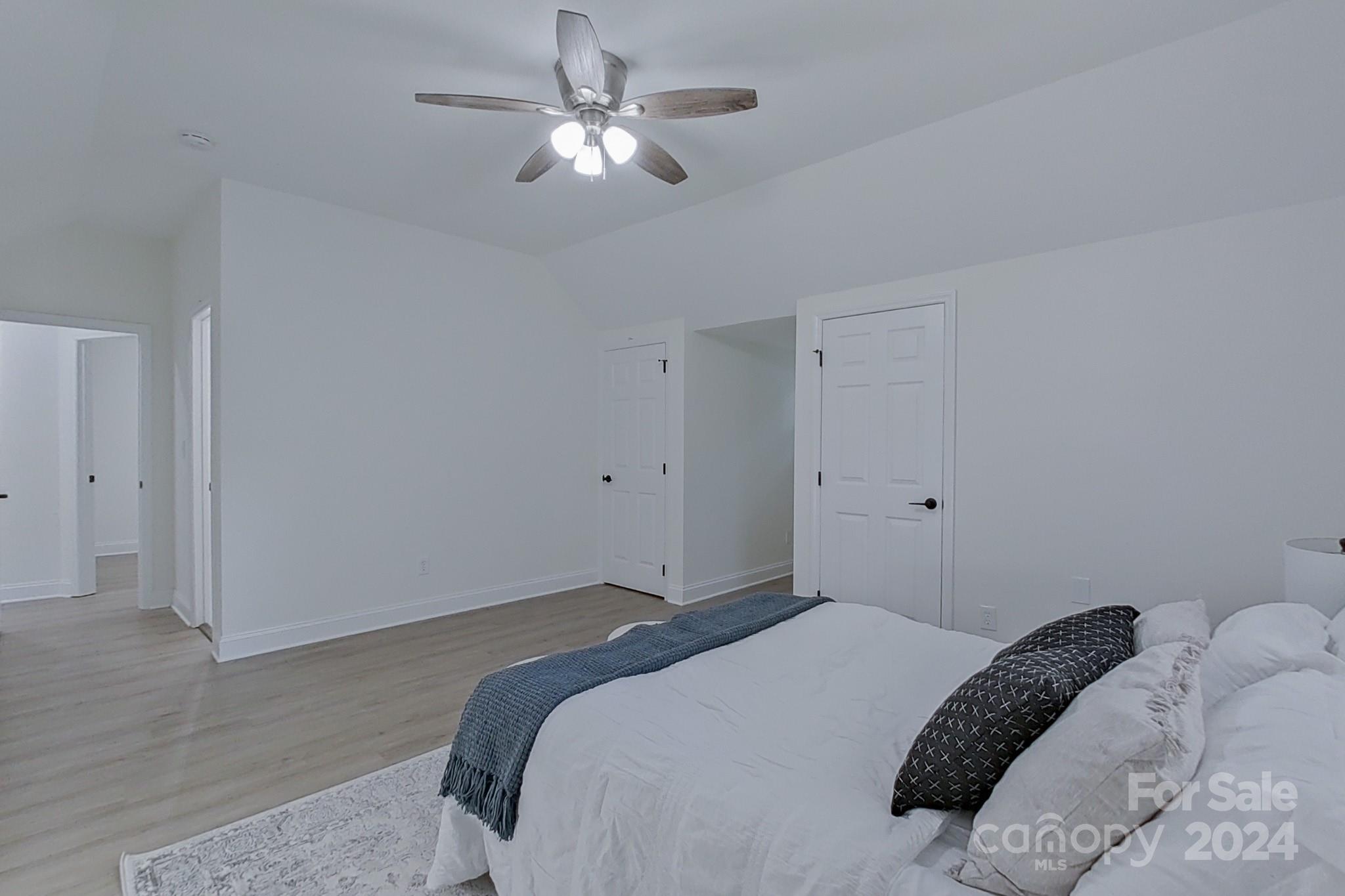 5710 Stream Ridge Drive Charlotte, NC 28269 - Photo 45 of 48 a bedroom with a large bed and a chandelier