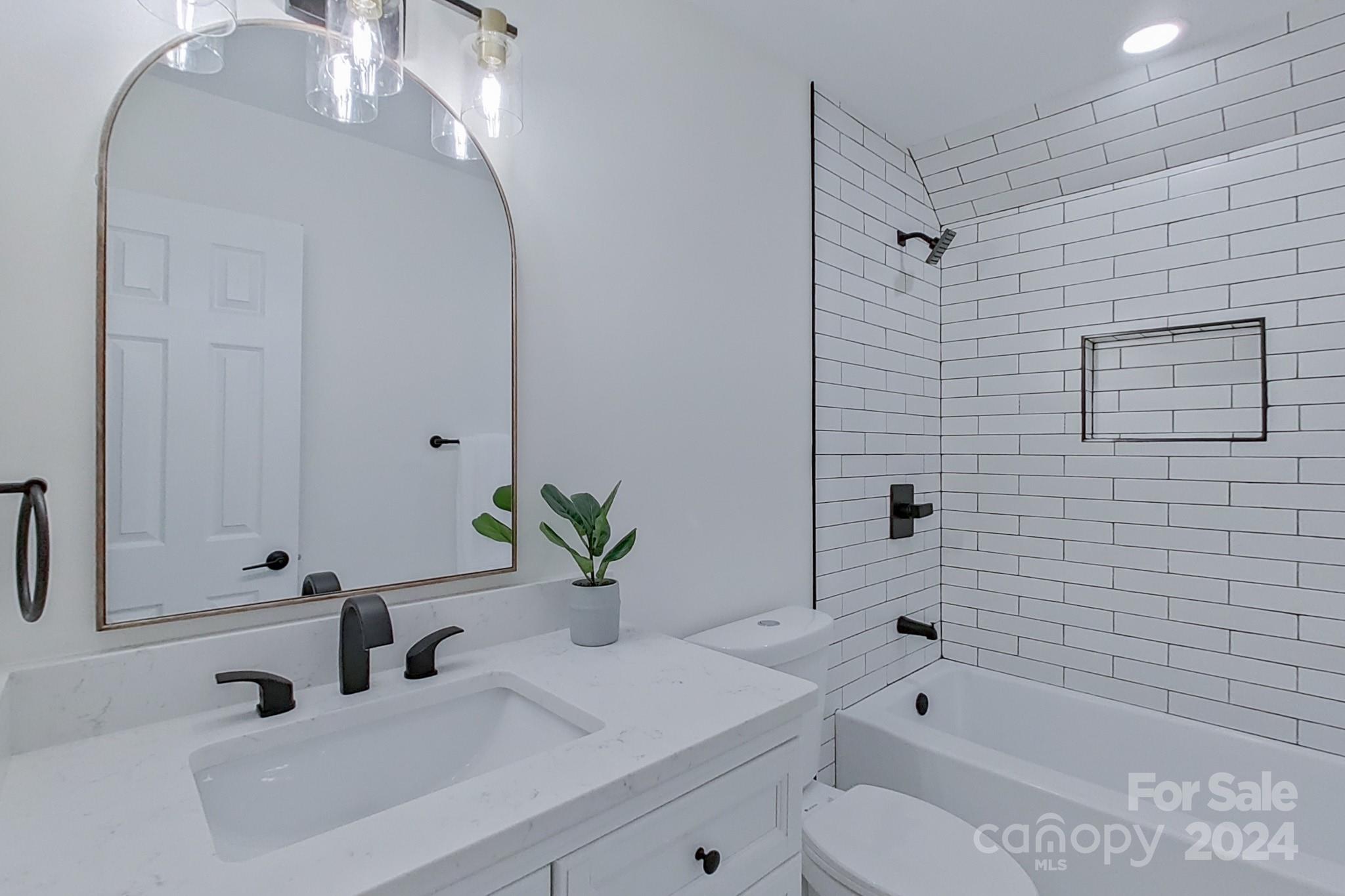 5710 Stream Ridge Drive Charlotte, NC 28269 - Photo 46 of 48 a bathroom with a sink a toilet and shower