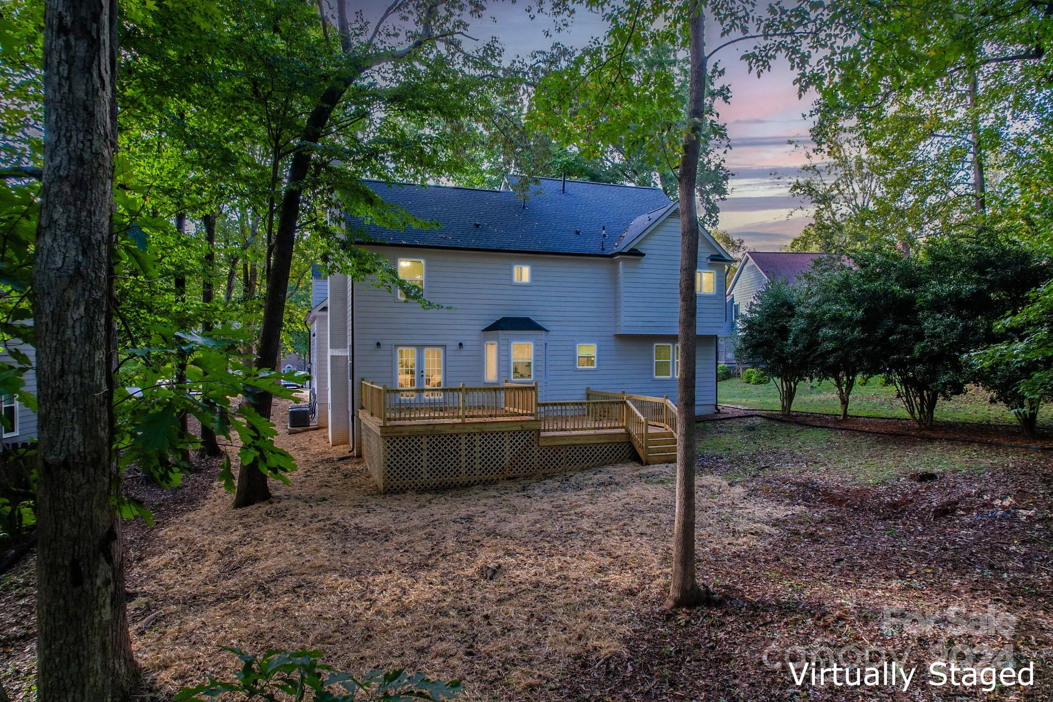 5710 Stream Ridge Drive Charlotte, NC 28269 - Photo 6 of 48 a front view of a house with a yard table and chairs