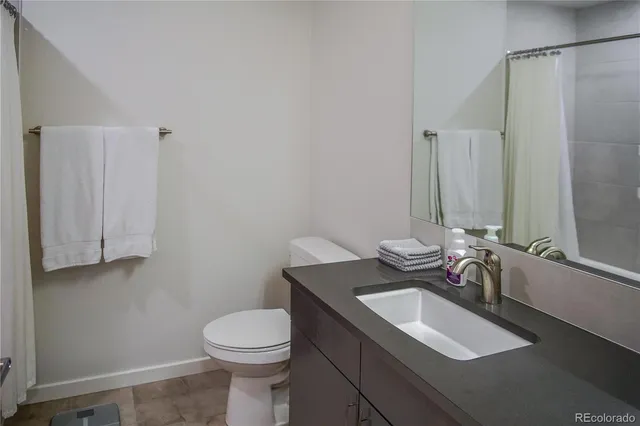 a bathroom with a sink toilet and a mirror