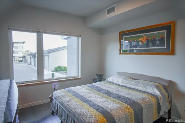 a bedroom with a bed and a large window