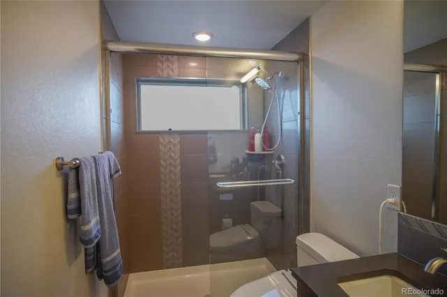 a bathroom with a shower and a toilet