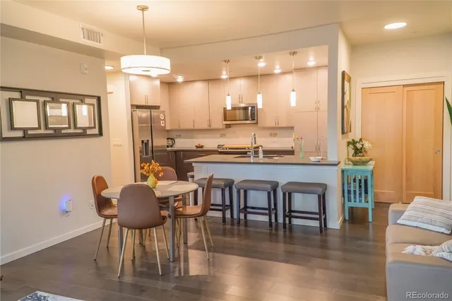 a dining room with furniture and wooden floor
