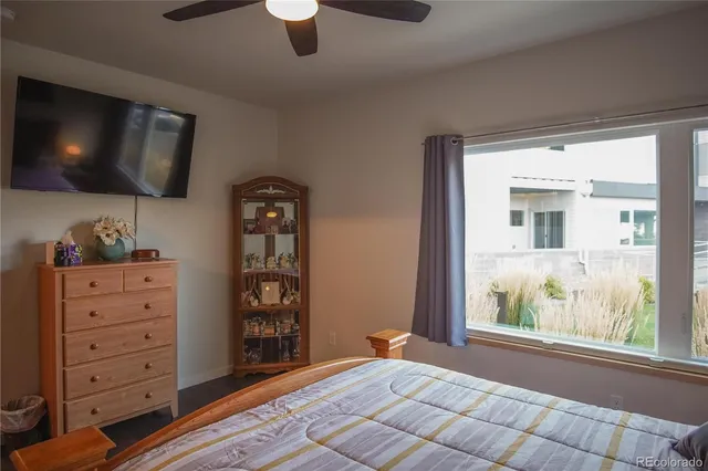 a bedroom with a bed and flat screen tv
