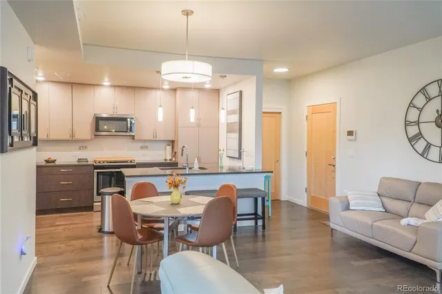 a view of kitchen with granite countertop cabinets table and chairs