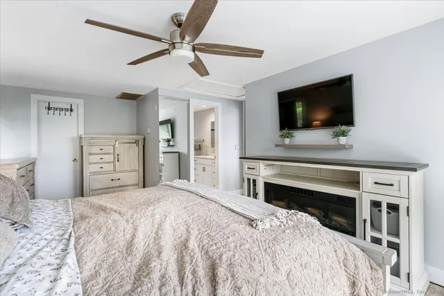 a bedroom with a bed and a flat screen tv