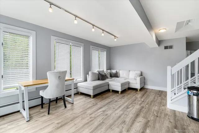 a living room with furniture and a wooden floor