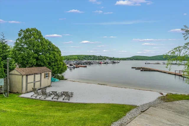 a view of a lake with houses in the back
