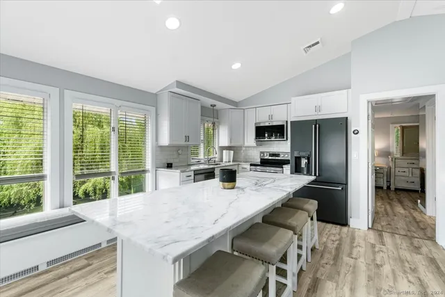 a kitchen with granite countertop center island and stainless steel appliances