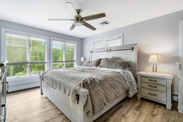 a bedroom with a bed and a large window