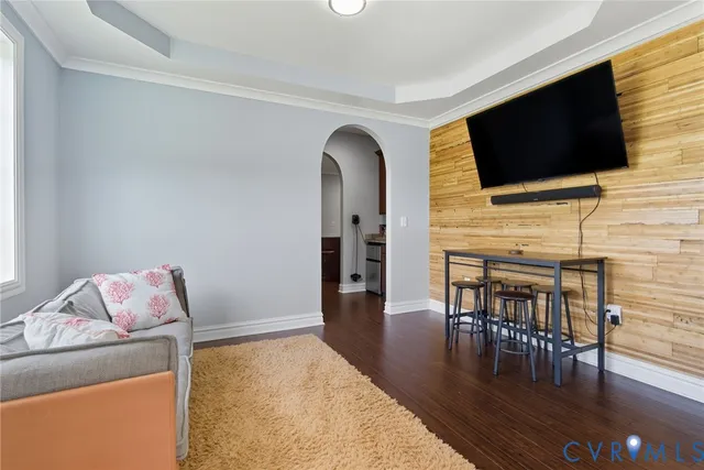 a living room with furniture and a flat screen tv