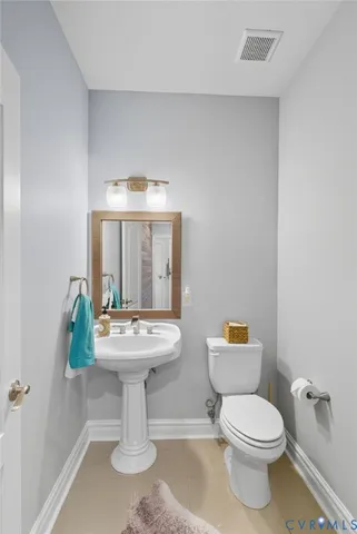 a bathroom with a sink toilet and a mirror