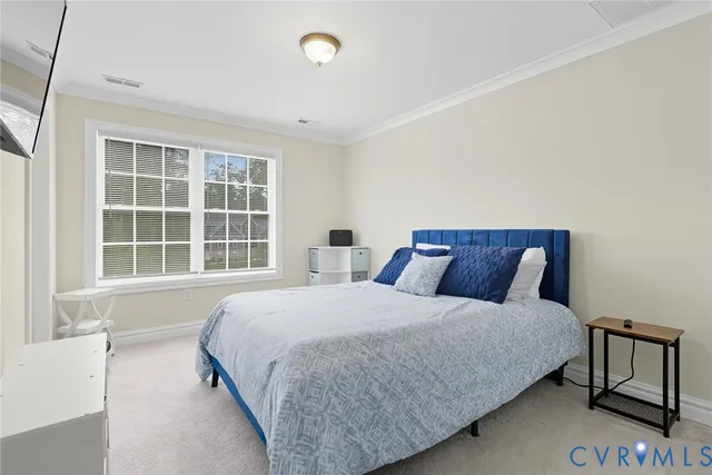 a bedroom with a large bed and a window