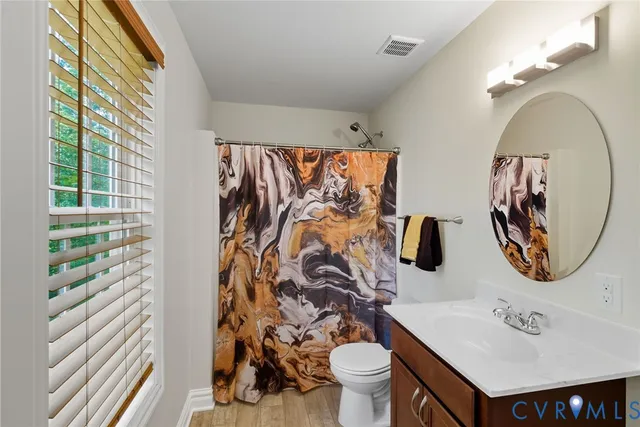 a bathroom with a sink toilet and a mirror