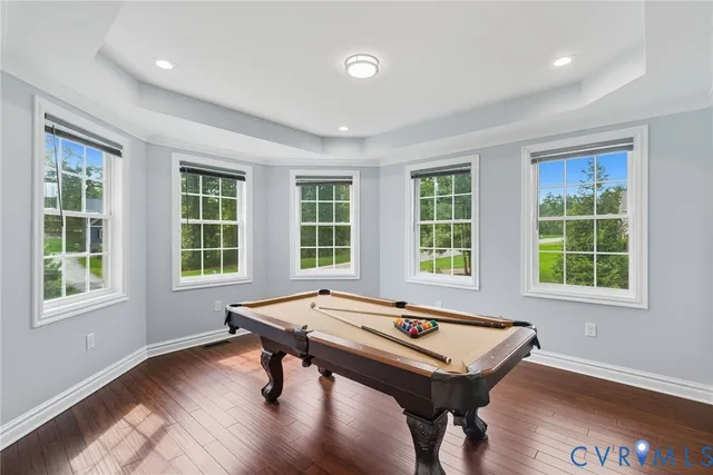 a living room with a table and windows