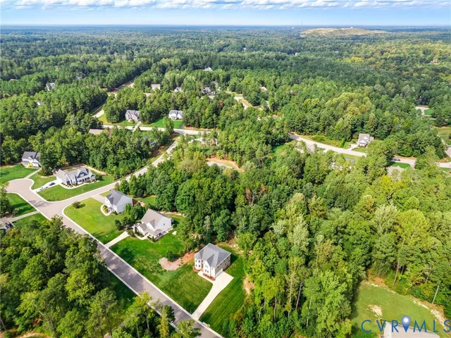 view of a green field with lots of bushes