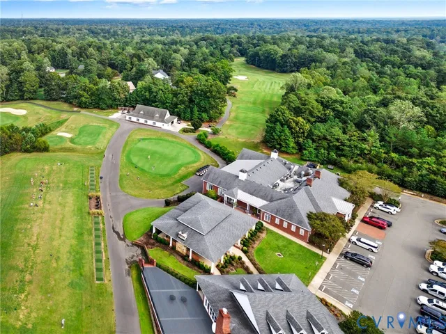 an aerial view of a house with a garden and lake view