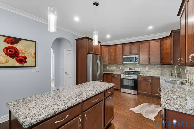 a kitchen with stainless steel appliances granite countertop a refrigerator and stove